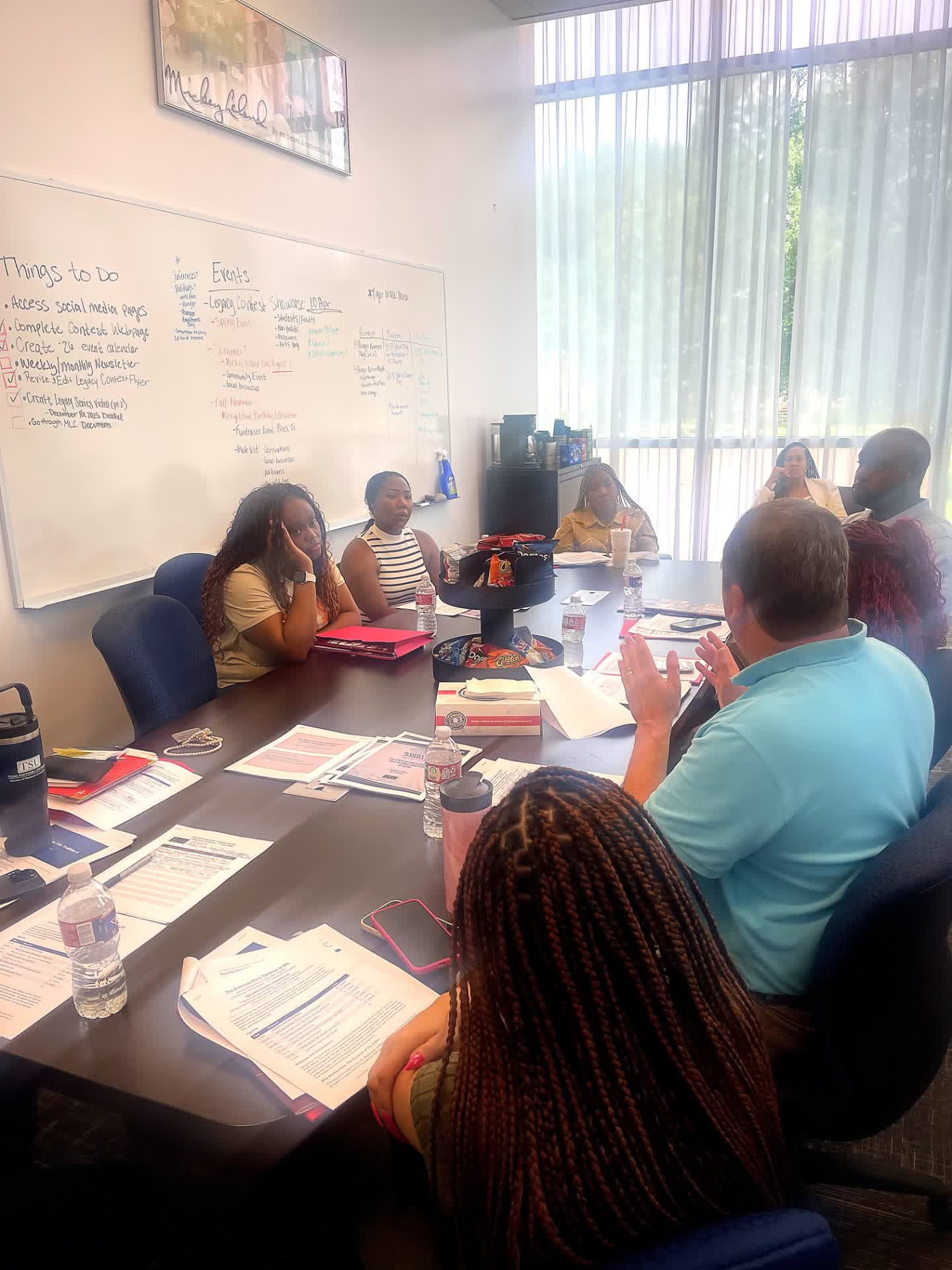 Teachers and program staff seated around a conference table during the July 2026 Civics Seminar at Texas Southern University.