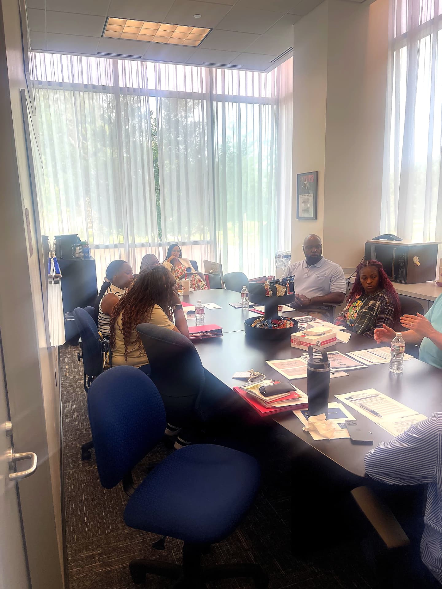 Cohort educators reviewing program materials in a sunlit conference room at the July 2026 Civics Seminar.